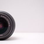 Detailed close-up shot of a Nikon AF-S DX NIKKOR lens on a white background.